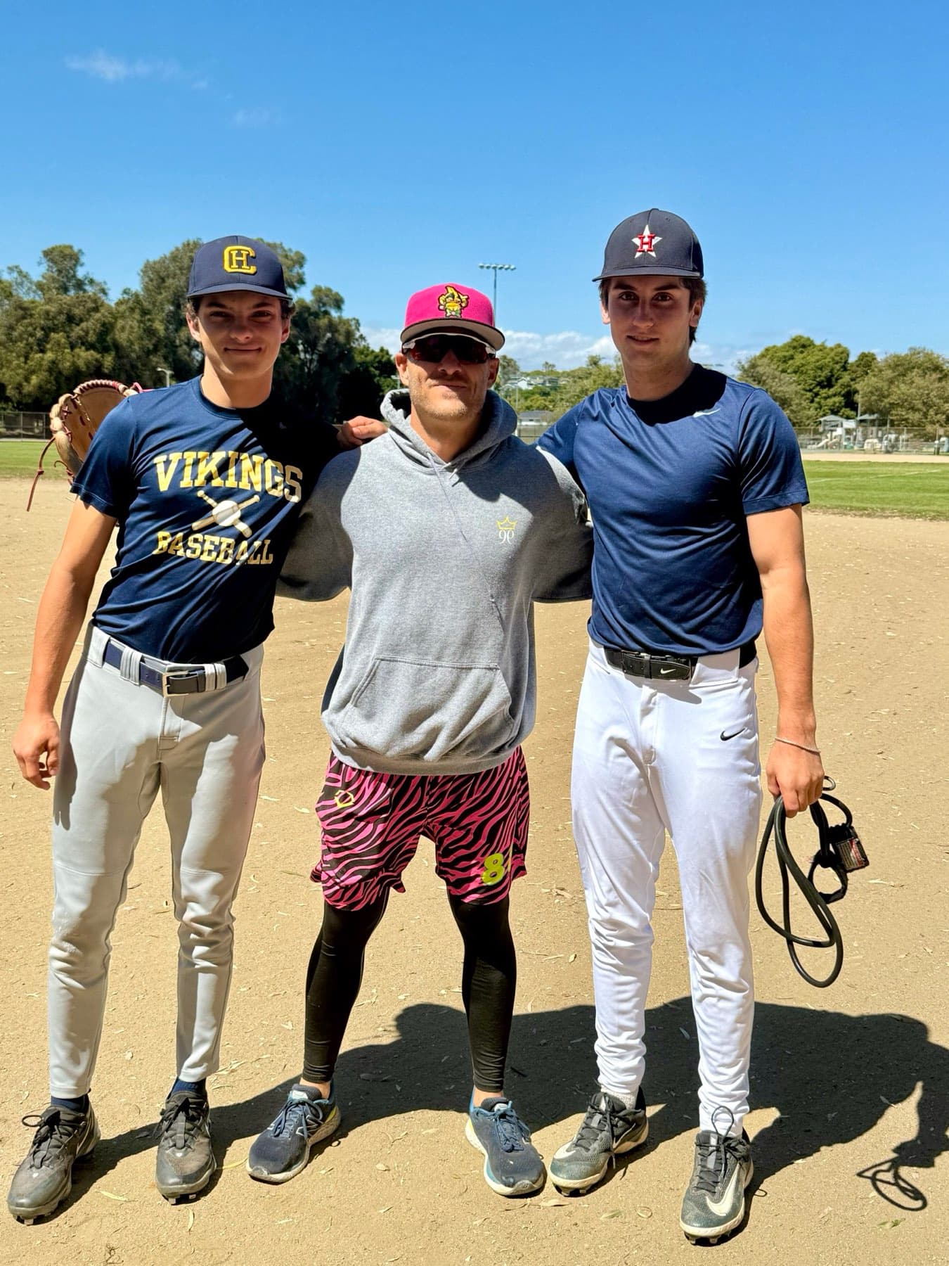 Coach Isaac Hess with two adult players after a session
