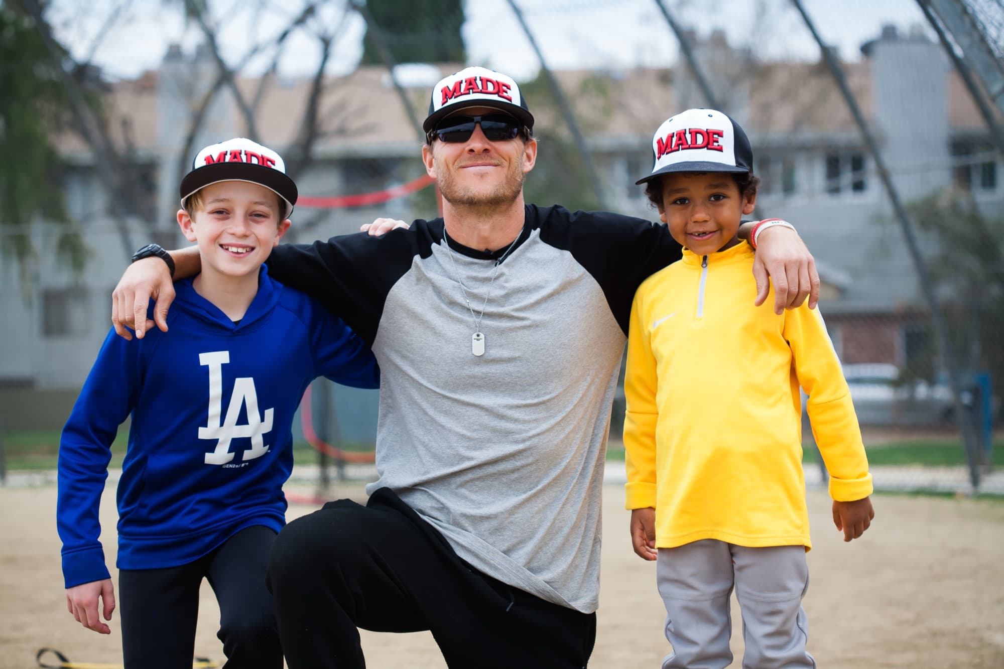 Coach Isaac Hess with two young players after a lesson