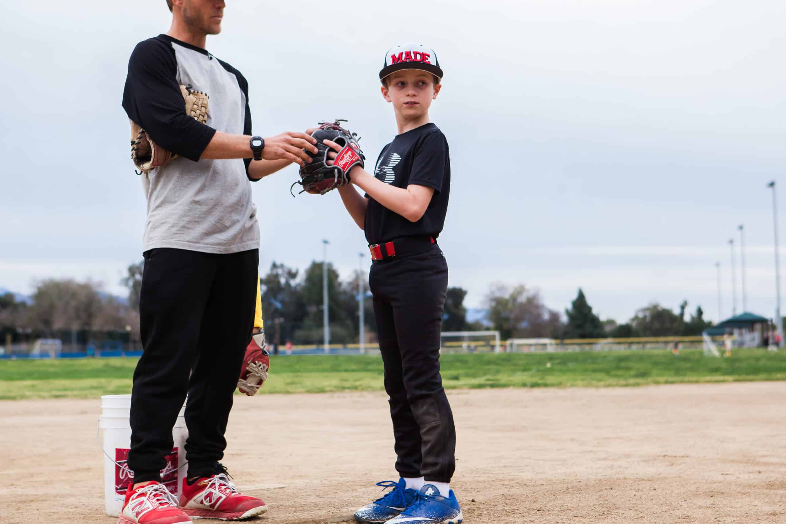 Baseball player working through a structured drill with a coach